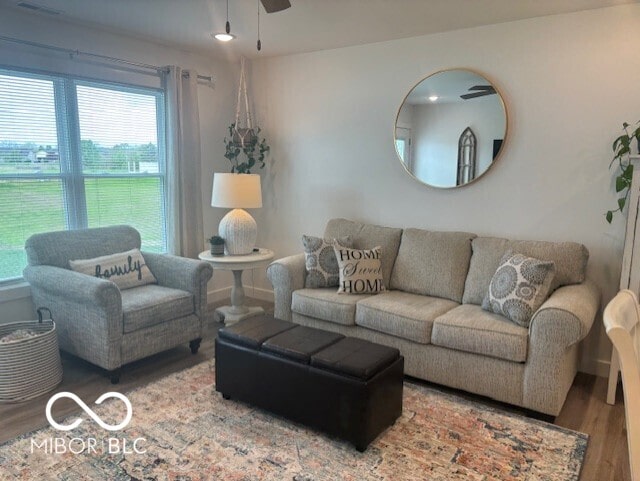 1511 Coen Ct, Columbus, IN 47201 - living area featuring baseboards, visible vents, wood finished floors, and a ceiling fan