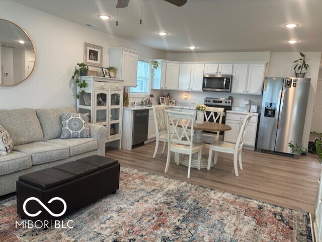 1511 Coen Ct, Columbus, IN 47201 - living room with ceiling fan, recessed lighting, and light wood-style floors