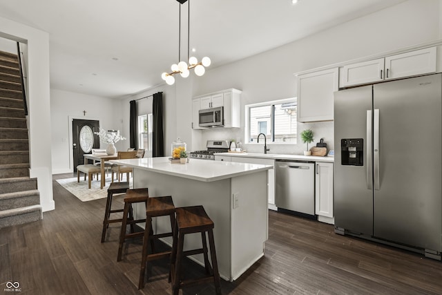 629 N Keystone Ave, Indianapolis, IN 46201 - kitchen with appliances with stainless steel finishes, a sink, a center island, white cabinetry, and light countertops