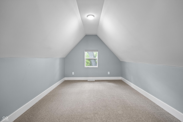 629 N Keystone Ave, Indianapolis, IN 46201 - bonus room featuring baseboards, lofted ceiling, and carpet