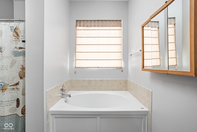 full bathroom featuring a garden tub and curtained shower