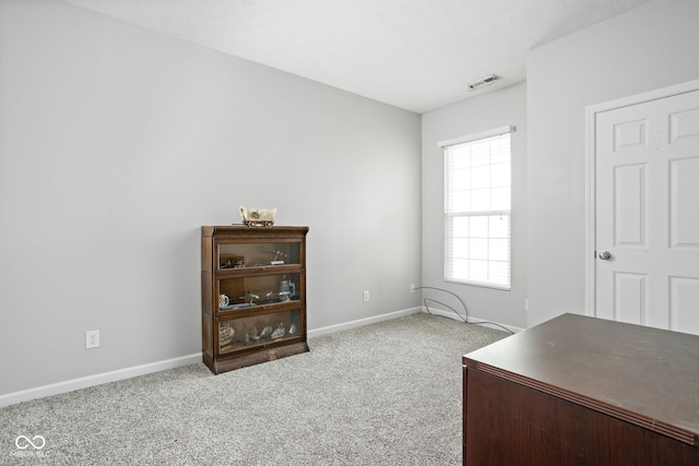 office area featuring carpet flooring, baseboards, and visible vents