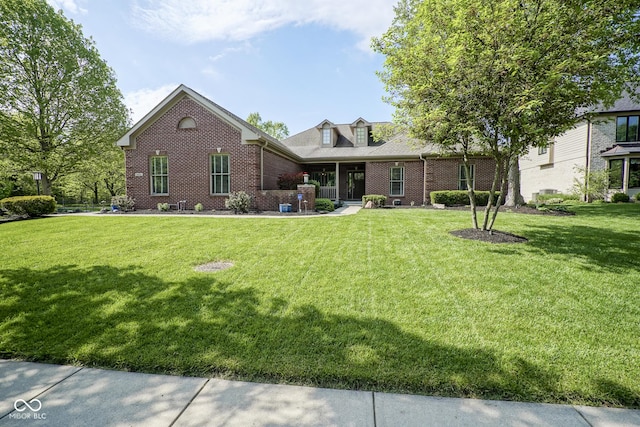 view of front of house with brick siding and a front yard