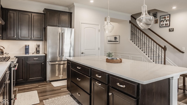 14878 Anees Ln, Fishers, IN 46040 - kitchen with appliances with stainless steel finishes, dark wood-type flooring, light countertops, a center island, and tasteful backsplash