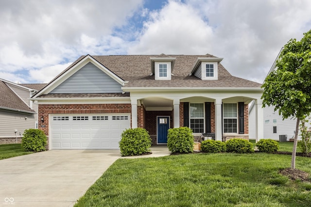 14878 Anees Ln, Fishers, IN 46040 - view of front facade featuring covered porch, concrete driveway, a front yard, and brick siding