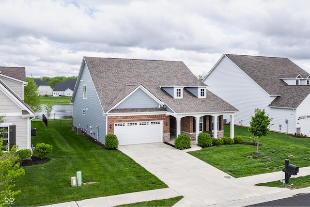 14878 Anees Ln, Fishers, IN 46040 - view of front of house with a porch, concrete driveway, a shingled roof, brick siding, and a garage