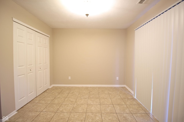 6634 Frankenberger Dr, Indianapolis, IN 46237 - unfurnished bedroom with light tile patterned floors and a closet