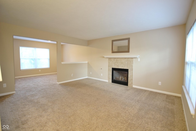 6634 Frankenberger Dr, Indianapolis, IN 46237 - unfurnished living room featuring a tile fireplace, carpet floors, and healthy amount of natural light
