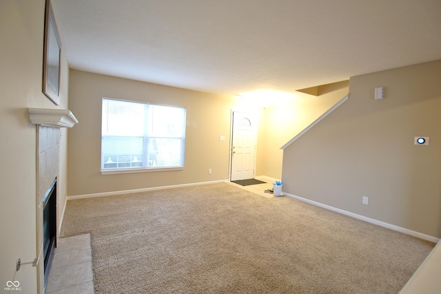 6634 Frankenberger Dr, Indianapolis, IN 46237 - unfurnished living room with a tiled fireplace and light colored carpet