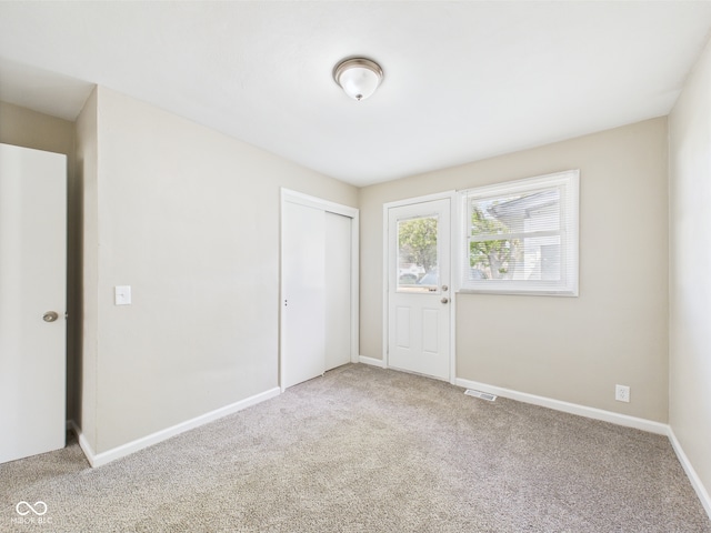 interior space with carpet floors, baseboards, visible vents, and a closet