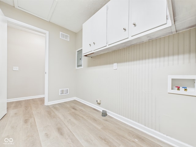 laundry area featuring hookup for a washing machine, light wood-type flooring, cabinet space, and visible vents