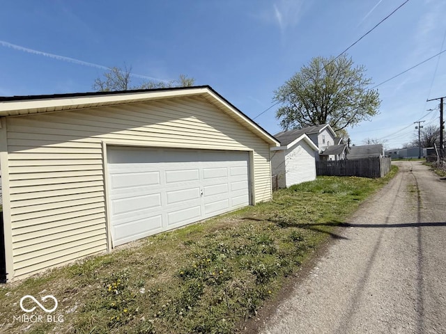 detached garage featuring fence