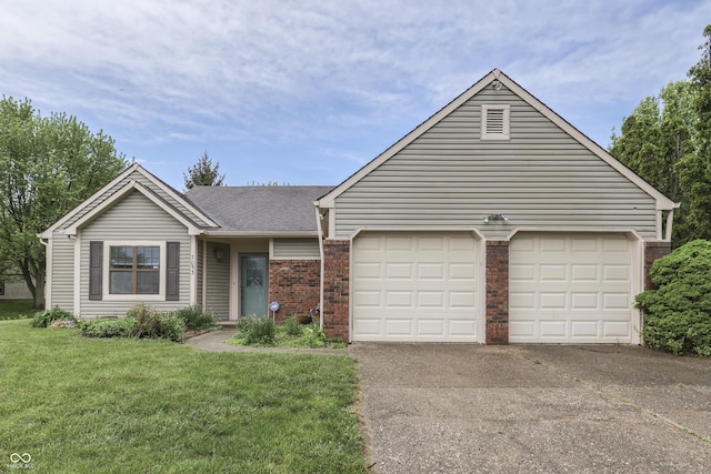 ranch-style home with a front lawn, roof with shingles, brick siding, an attached garage, and driveway