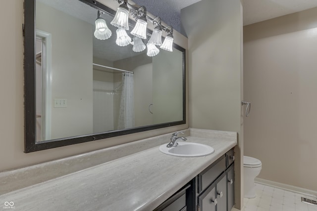 full bathroom with visible vents, vanity, toilet, baseboards, and tile patterned floors