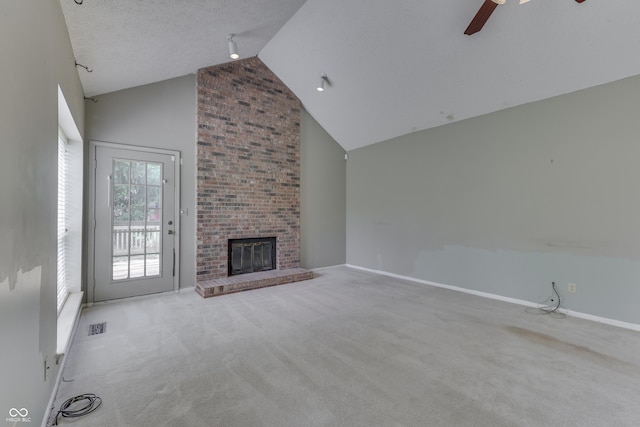 unfurnished living room with carpet floors, a ceiling fan, high vaulted ceiling, and visible vents