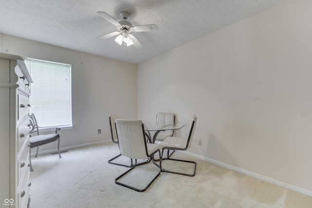 dining space with a textured ceiling, visible vents, light carpet, and baseboards