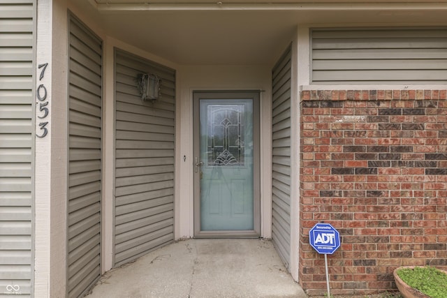 entrance to property with brick siding