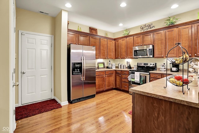 kitchen featuring recessed lighting, appliances with stainless steel finishes, light wood finished floors, and visible vents