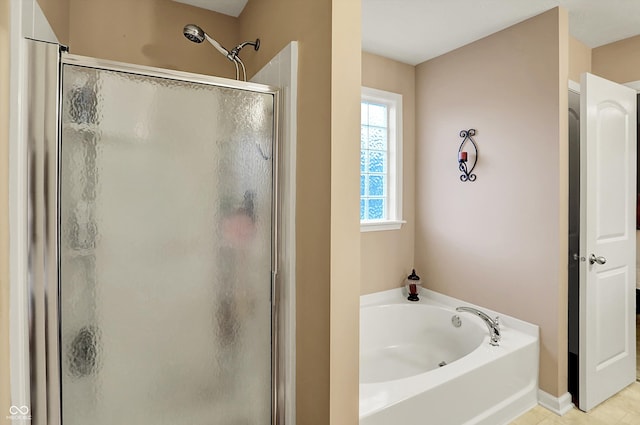 bathroom featuring a shower stall and a garden tub