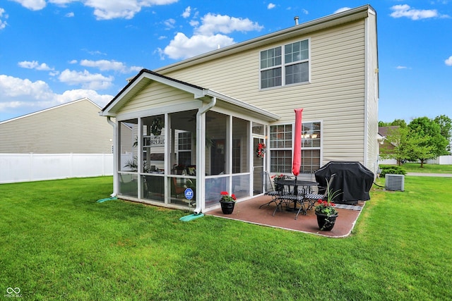 back of property featuring a sunroom, fence, a yard, and a patio