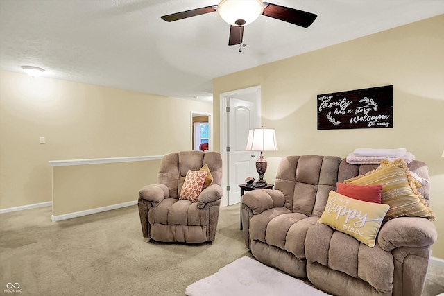 living room featuring carpet floors, baseboards, and ceiling fan