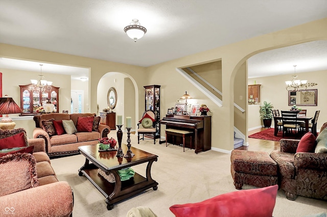 living area with stairs, arched walkways, and a chandelier