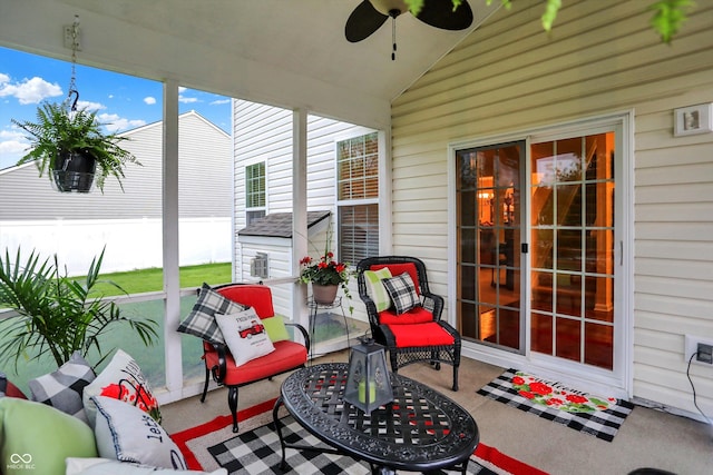 sunroom / solarium featuring ceiling fan