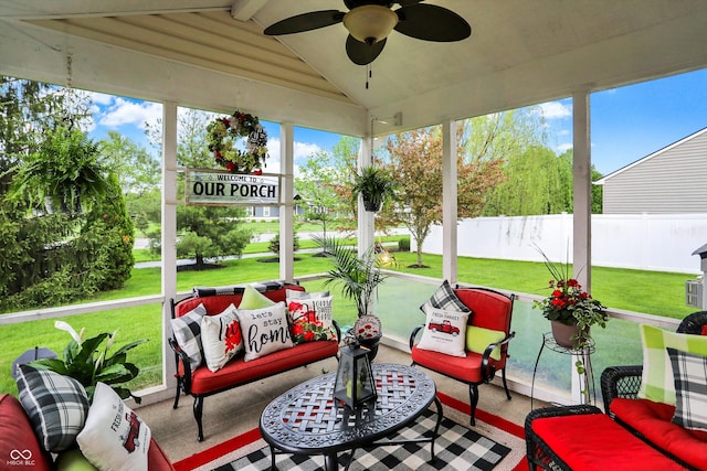 sunroom / solarium featuring a ceiling fan, beamed ceiling, and an outdoor hangout area