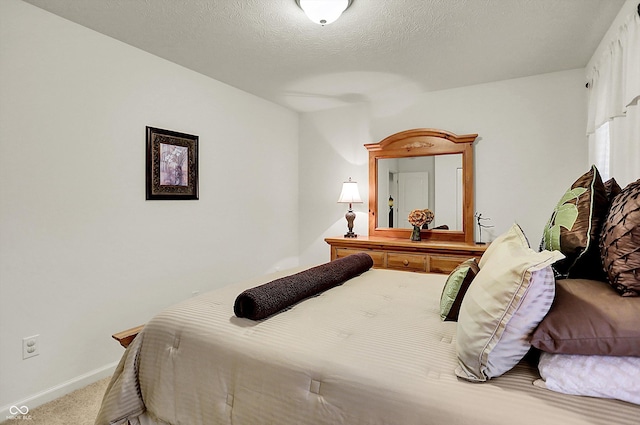 bedroom featuring carpet floors, a textured ceiling, and baseboards