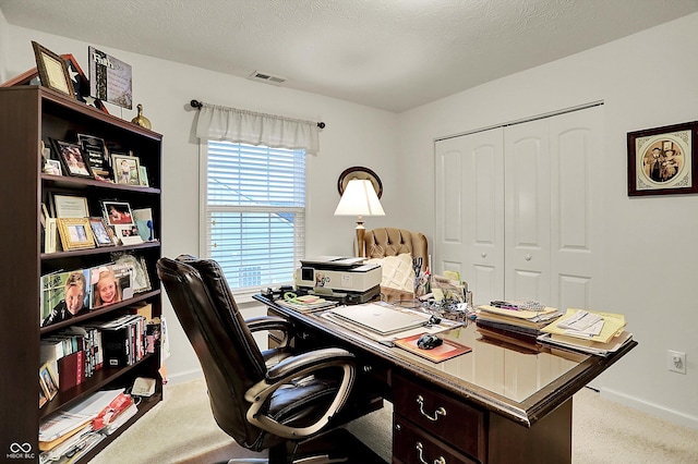 office space featuring baseboards, light colored carpet, and visible vents