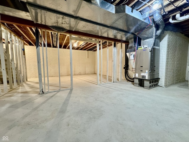 unfinished basement featuring heating unit