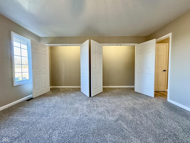 unfurnished bedroom featuring baseboards and carpet