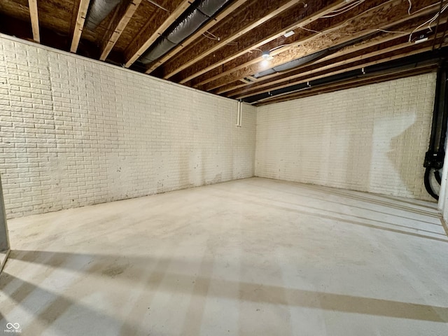 unfinished basement featuring brick wall