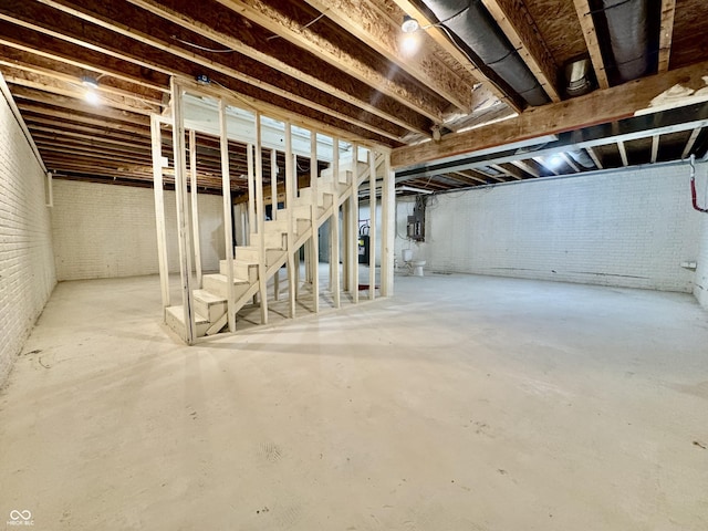 unfinished below grade area with brick wall and stairs
