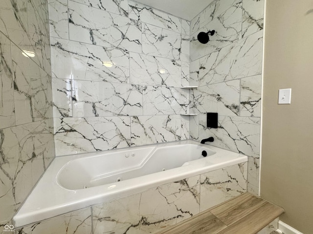 bathroom with baseboards and a combined bath / shower with jetted tub