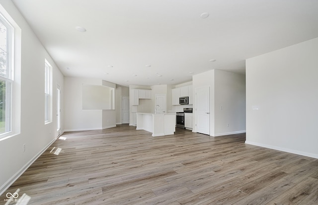 6871 Seabiscuit Rd, Whitestown, IN 46075 - unfurnished living room featuring light wood-type flooring