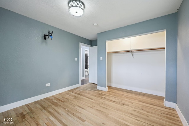 1416 Wellington Ave, Indianapolis, IN 46219 - unfurnished bedroom featuring light wood-style floors, baseboards, and a closet