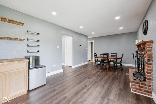 1416 Wellington Ave, Indianapolis, IN 46219 - dining space featuring dark wood-style flooring, baseboards, recessed lighting, and a fireplace