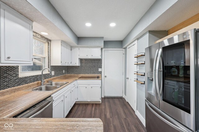 1416 Wellington Ave, Indianapolis, IN 46219 - kitchen featuring a sink, appliances with stainless steel finishes, backsplash, and dark wood-style floors