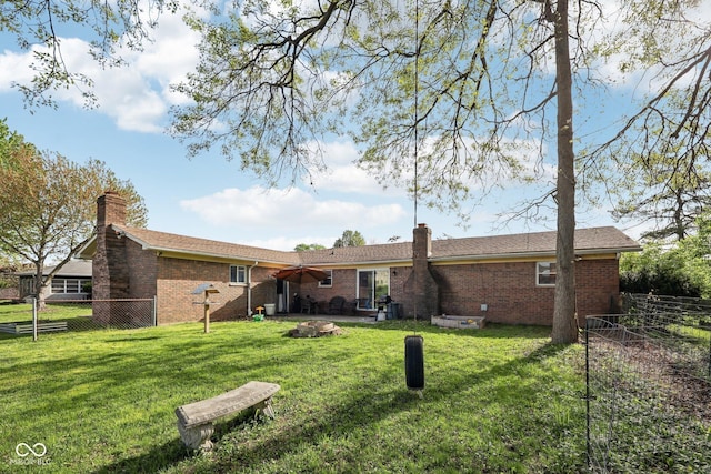 1416 Wellington Ave, Indianapolis, IN 46219 - back of property featuring fence, a chimney, and brick siding