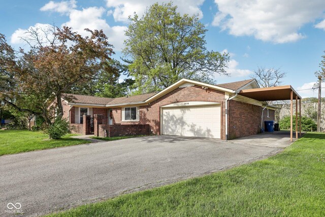 1416 Wellington Ave, Indianapolis, IN 46219 - ranch-style house with a front lawn, brick siding, a garage, aphalt driveway, and a carport