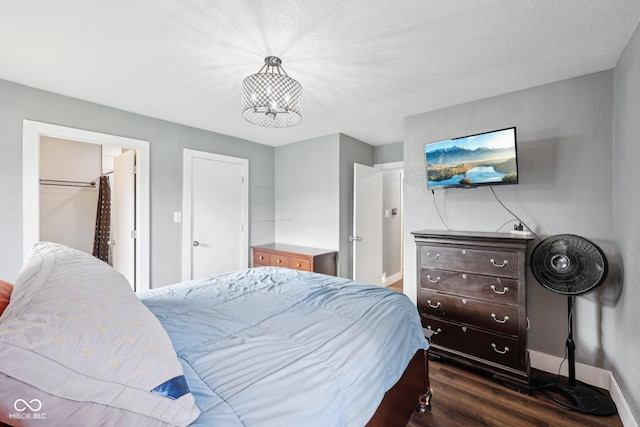1416 Wellington Ave, Indianapolis, IN 46219 - bedroom featuring baseboards, dark wood finished floors, and a chandelier