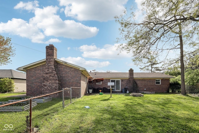 1416 Wellington Ave, Indianapolis, IN 46219 - back of property featuring brick siding, a lawn, fence, and a chimney