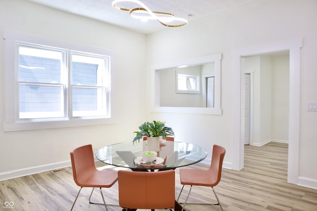 474 N Randolph St, Indianapolis, IN 46201 - dining area with baseboards, a chandelier, and wood finished floors