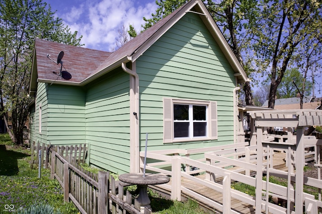 474 N Randolph St, Indianapolis, IN 46201 - view of property exterior featuring a shingled roof and fence