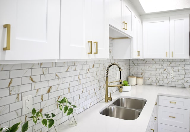 474 N Randolph St, Indianapolis, IN 46201 - kitchen featuring light countertops, white cabinetry, decorative backsplash, and a sink