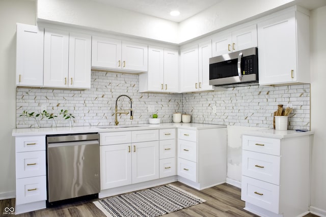 474 N Randolph St, Indianapolis, IN 46201 - kitchen with a sink, light countertops, stainless steel appliances, and wood finished floors