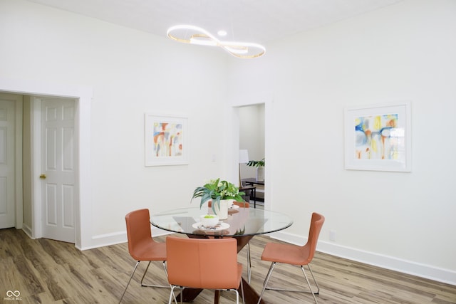474 N Randolph St, Indianapolis, IN 46201 - dining area featuring baseboards, a notable chandelier, and light wood-style flooring