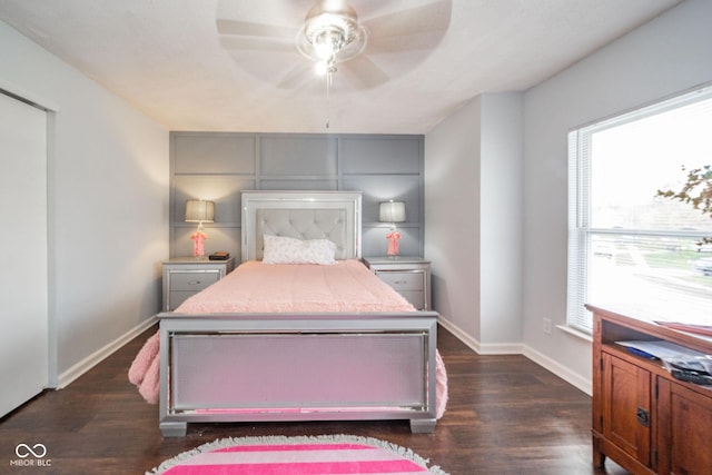 bedroom featuring baseboards, a ceiling fan, and dark wood-style flooring