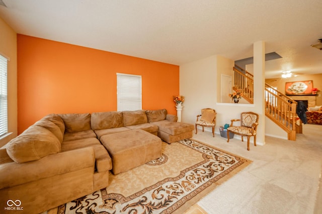 living area featuring carpet floors, a wealth of natural light, and stairway
